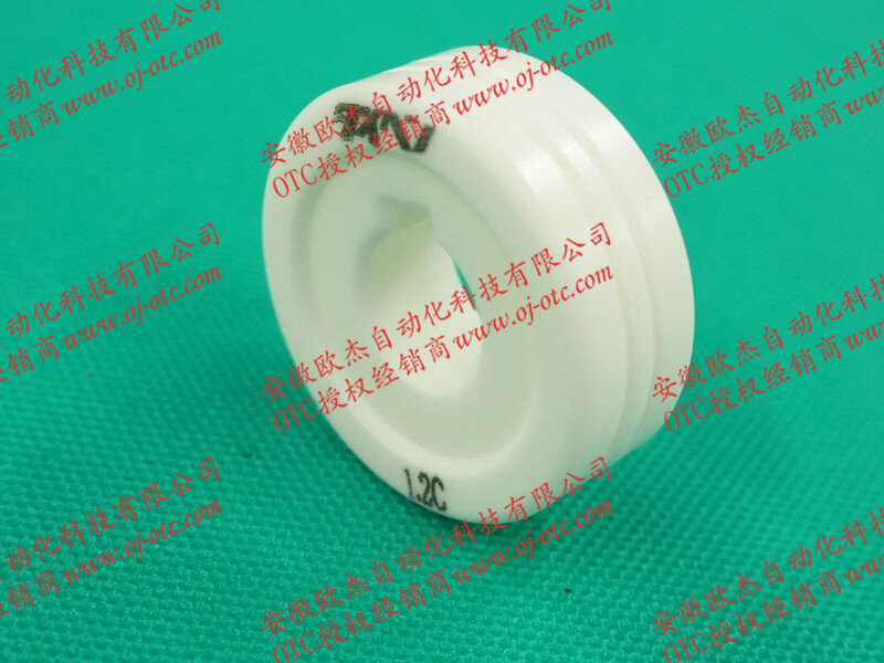 OTC DAIHEN K970E24 ceramic feed roller close-up with part number